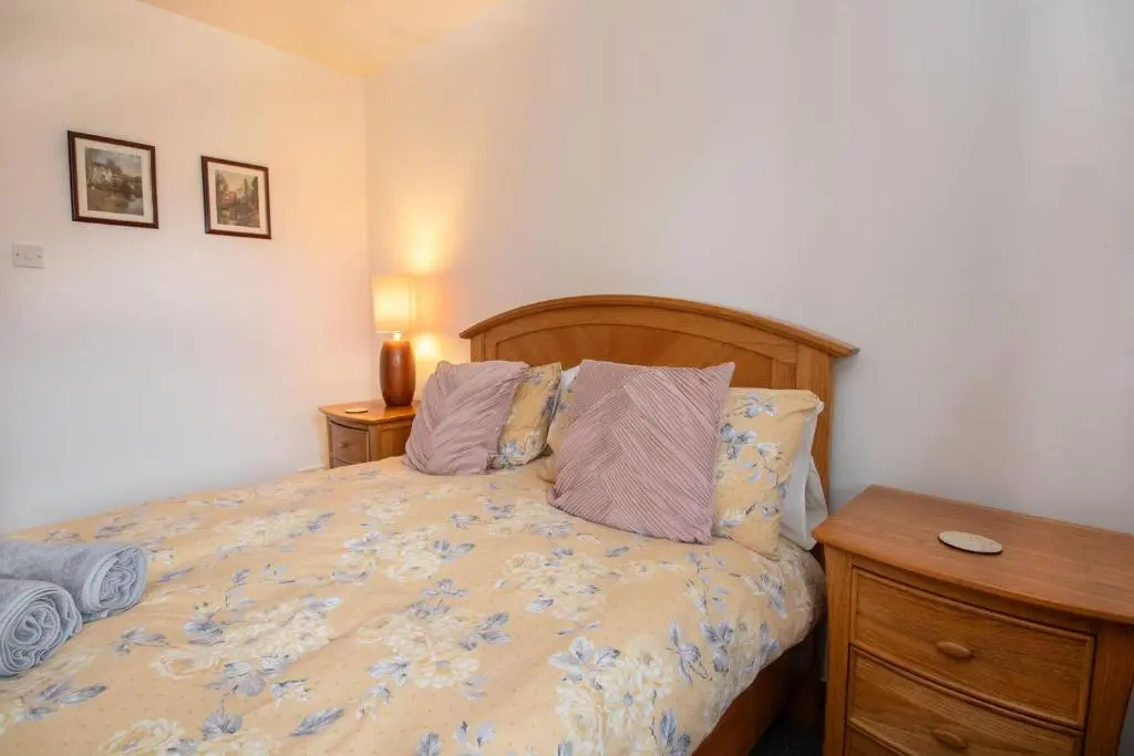 a bedroom with a bed with a wooden headboard at Boutique Four Bed Holiday Home in Inverness in Inverness