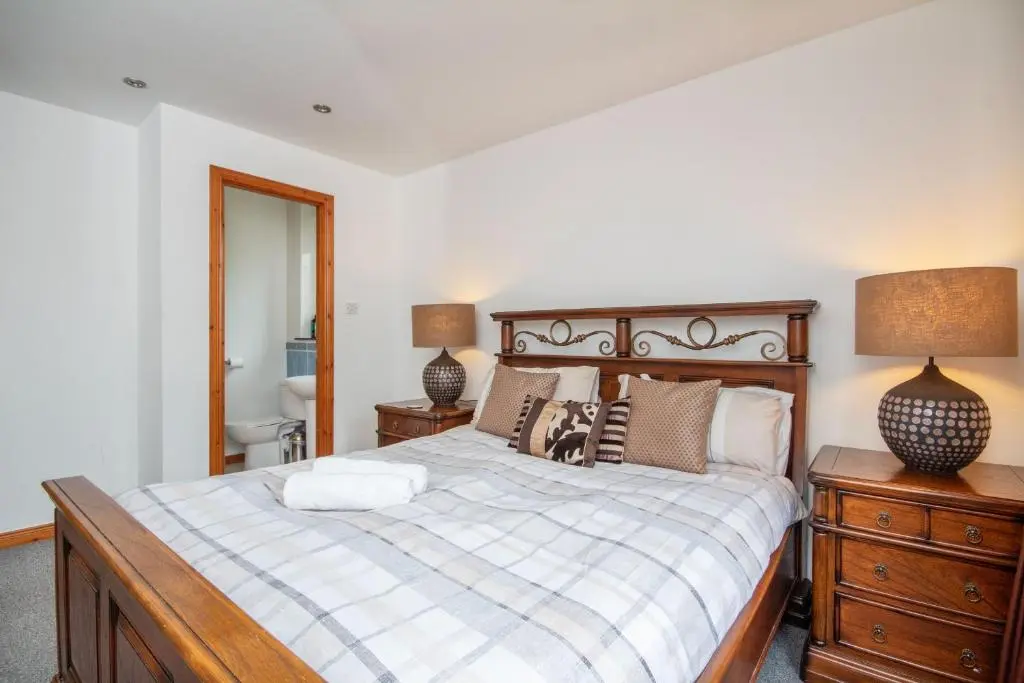 a bedroom with a large bed and two lamps at Boutique Four Bed Holiday Home in Inverness in Inverness
