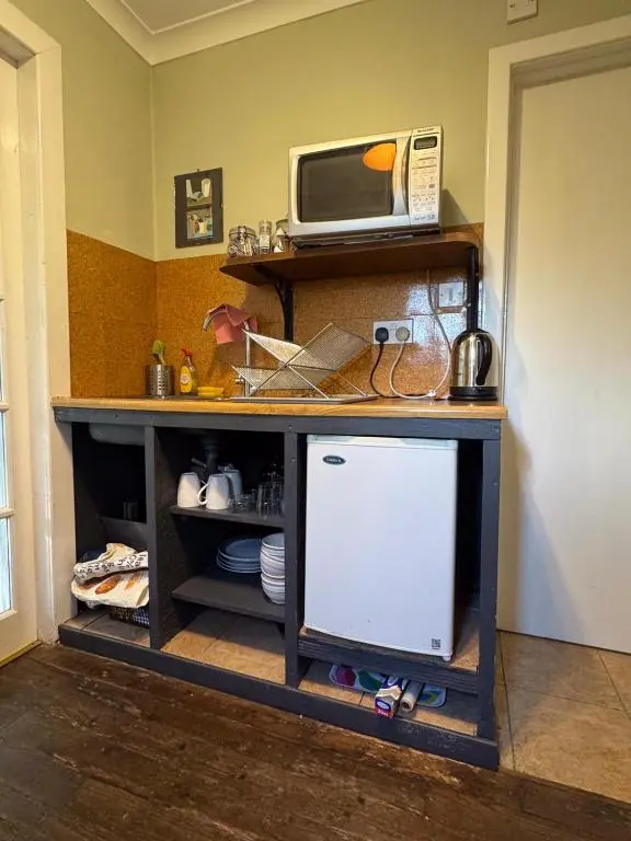 a counter with a microwave on top of it at Ullapool Lawyur's patch in Ullapool
