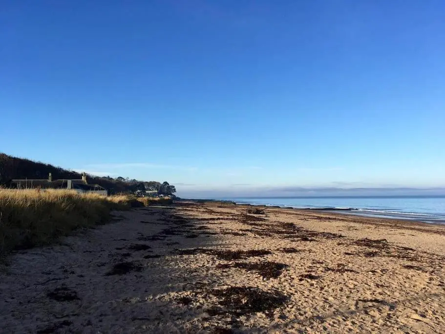 a sandy beach with the ocean in the background at Calailan Highland Seaside Retreat - Nairn in Nairn