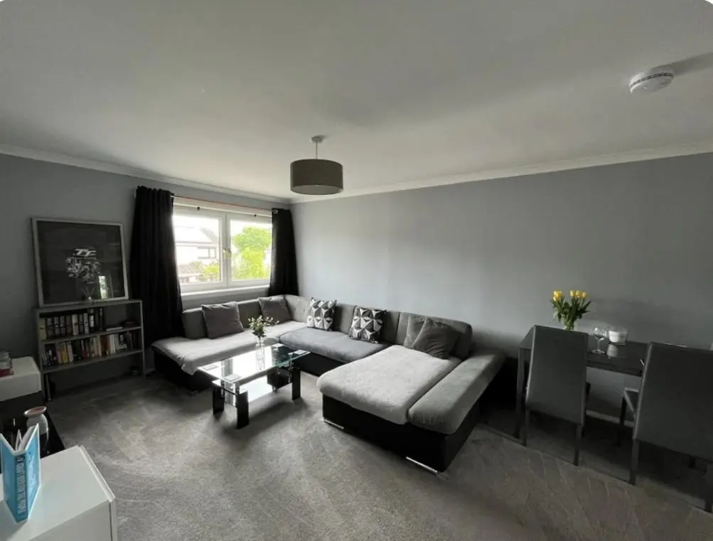 a living room with a couch and a table at Townhead Road in Inverurie