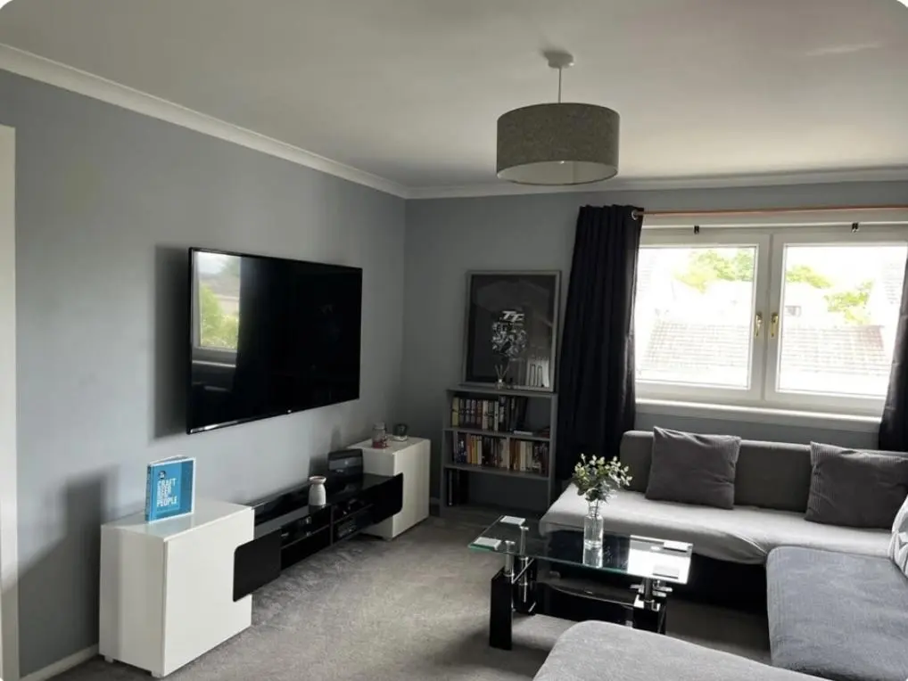 a living room with a couch and a flat screen tv at Townhead Road in Inverurie
