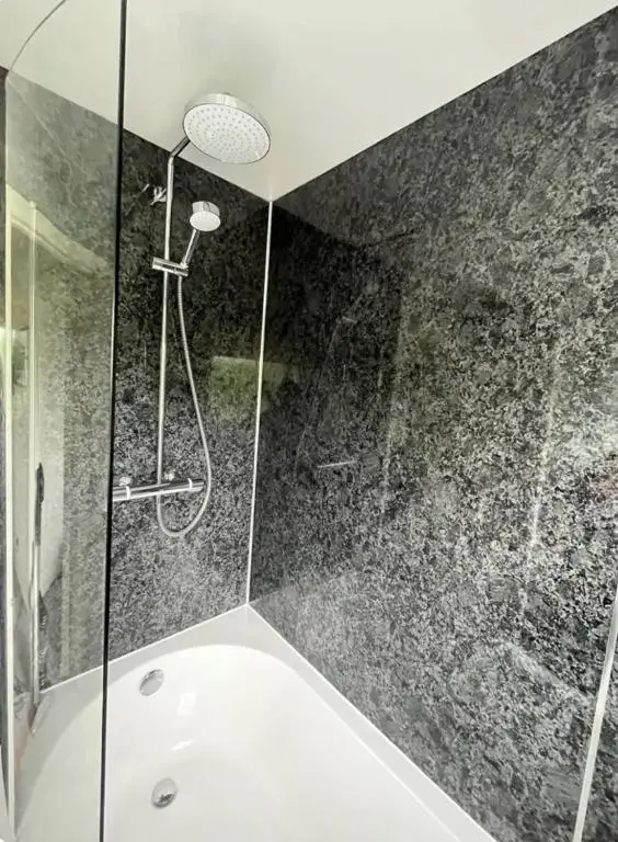 a bathroom with a shower and a bath tub at Townhead Road in Inverurie