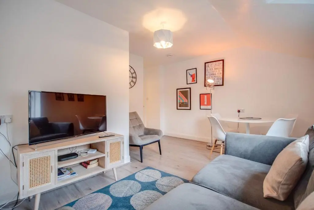 a living room with a couch and a tv at Comfortable 2-Bedroom Inverness Flat in Inverness