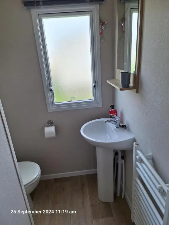 a bathroom with a sink and a window at Lewis Sands PC114 in Lossiemouth