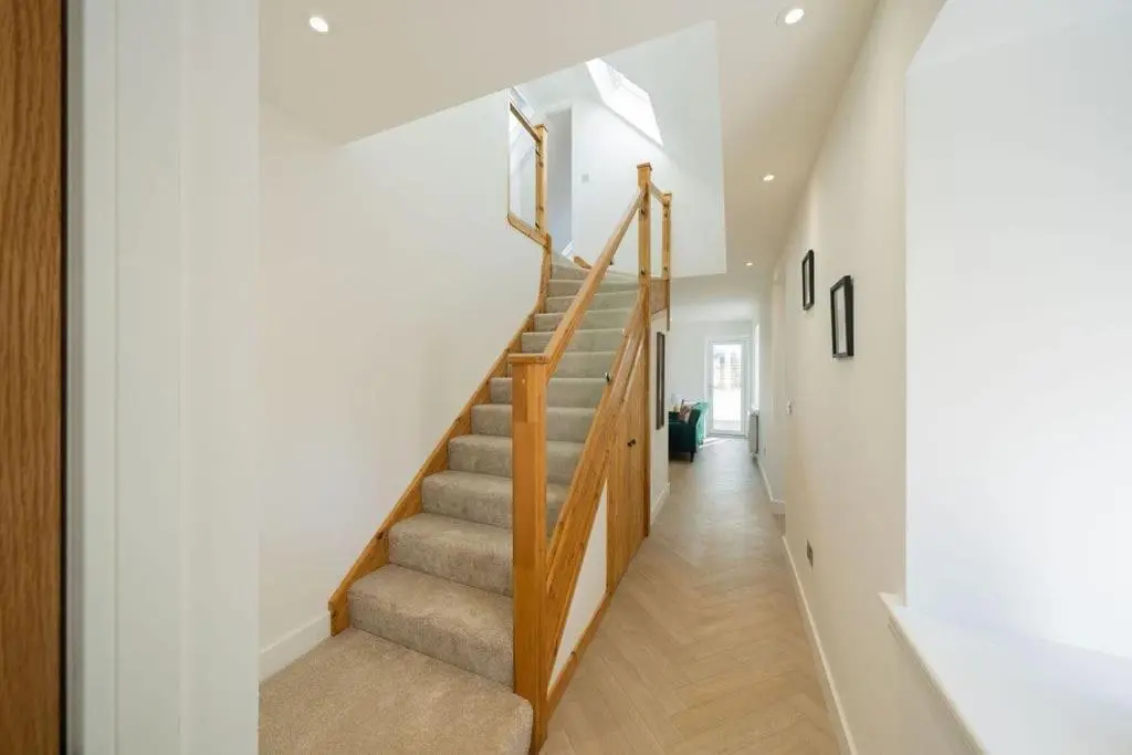a staircase in a home with white walls at Easter Cottage -4 Bed Converted Barn Cottage in Turriff