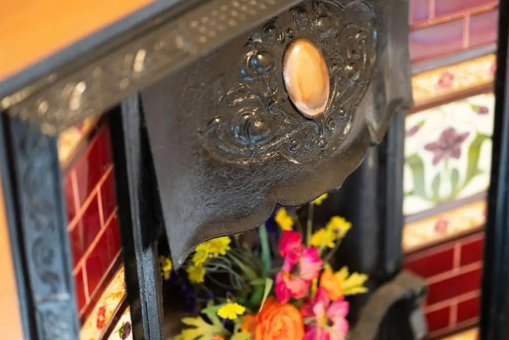a close up of a mirror with flowers in it at Red Squirrel Cottage, Family & Pet Friendly Adventure Retreat, Strathdon, Aberdeenshire in Towie