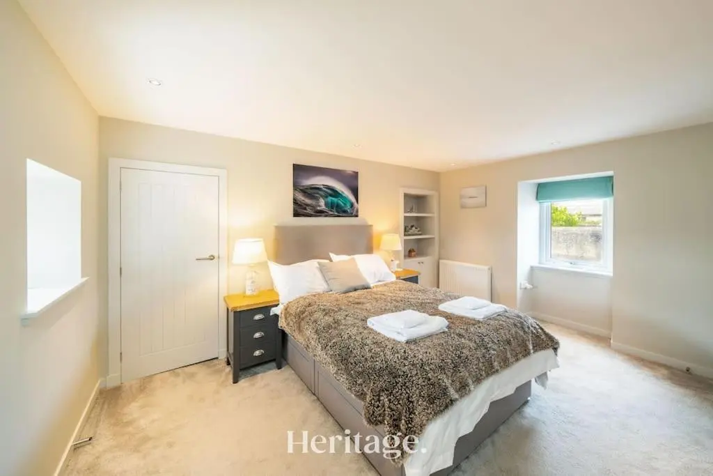 a bedroom with a bed with two pillows on it at Beach Cottage, Pet & Family Friendly Stay in Moray in Lossiemouth