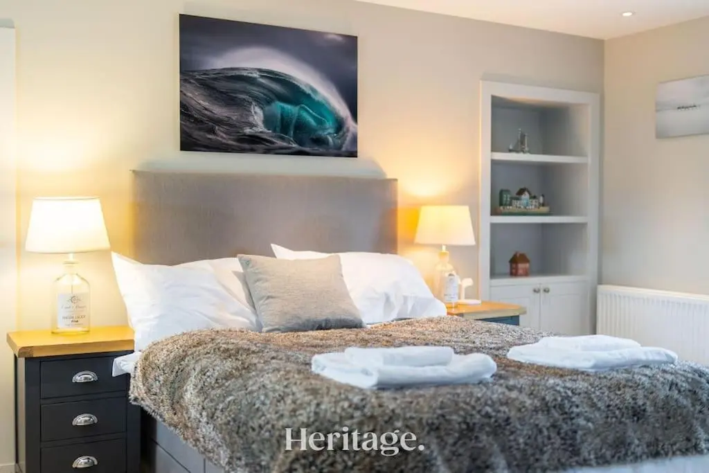 a bedroom with a bed with two towels on it at Beach Cottage, Pet & Family Friendly Stay in Moray in Lossiemouth