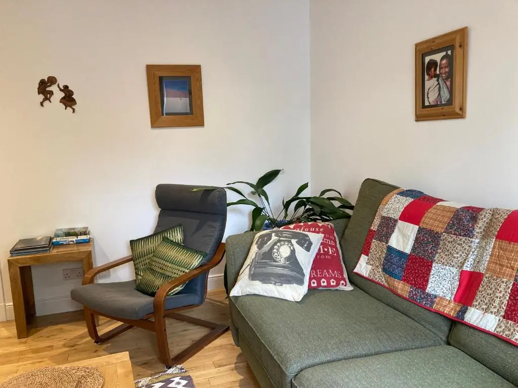 a living room with a couch and a chair at Flat 2 at Inverness City in Inverness