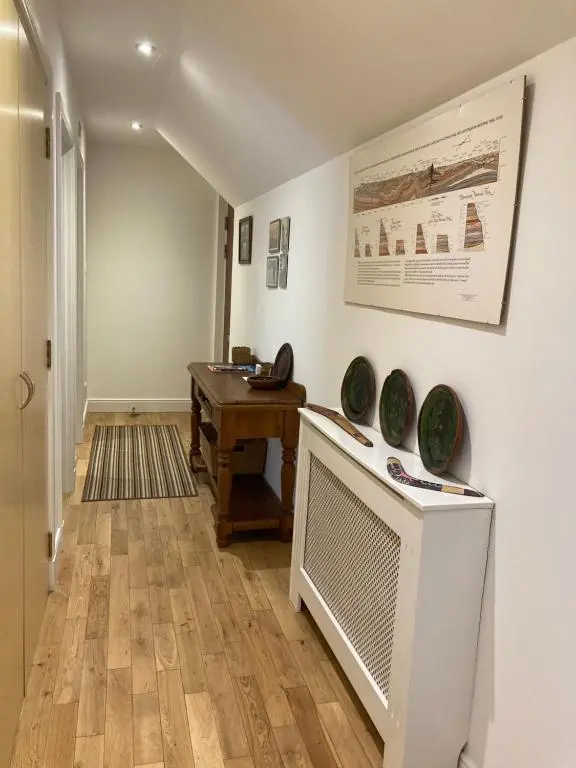 a living room with a table and a desk at Flat 2 at Inverness City in Inverness