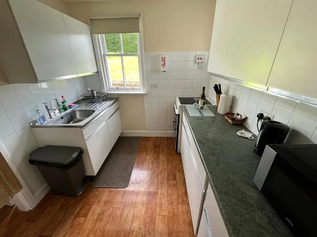 a small kitchen with a sink and a counter at Old Lock-keeper's Cottage in Fort Augustus