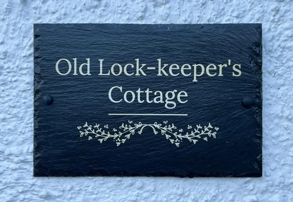 a sign that reads old lock keepers cottage at Old Lock-keeper's Cottage in Fort Augustus