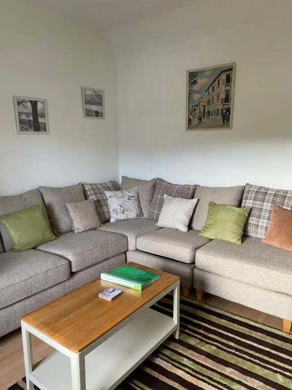 a living room with a couch and a coffee table at Dalvey Ploughmans Cottage in Forres