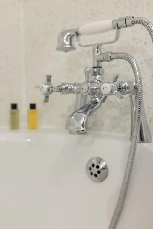 a bathroom sink with a faucet on top of it at Dalvey Abbotshill Farm House in Forres