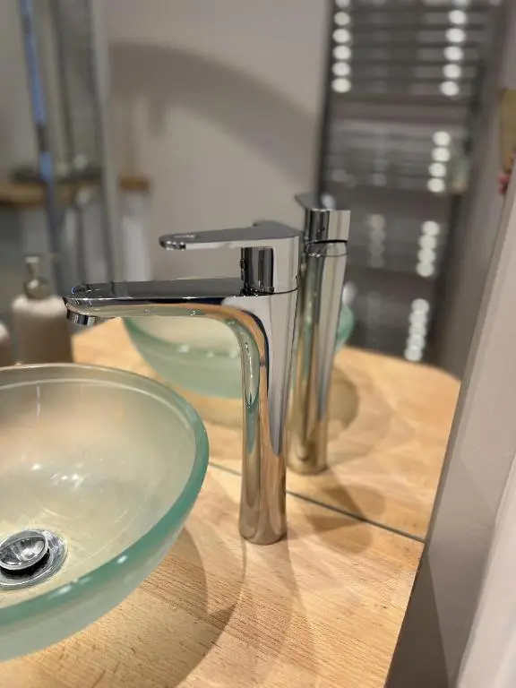 a bathroom sink with a faucet on a wooden counter at No. Ten Guesthouse in Tain