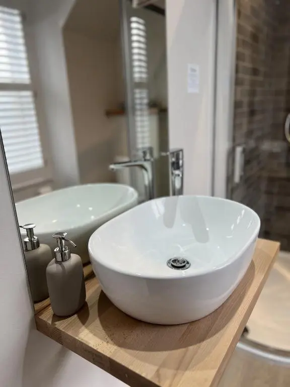 a bathroom with a white sink and a mirror at No. Ten Guesthouse in Tain
