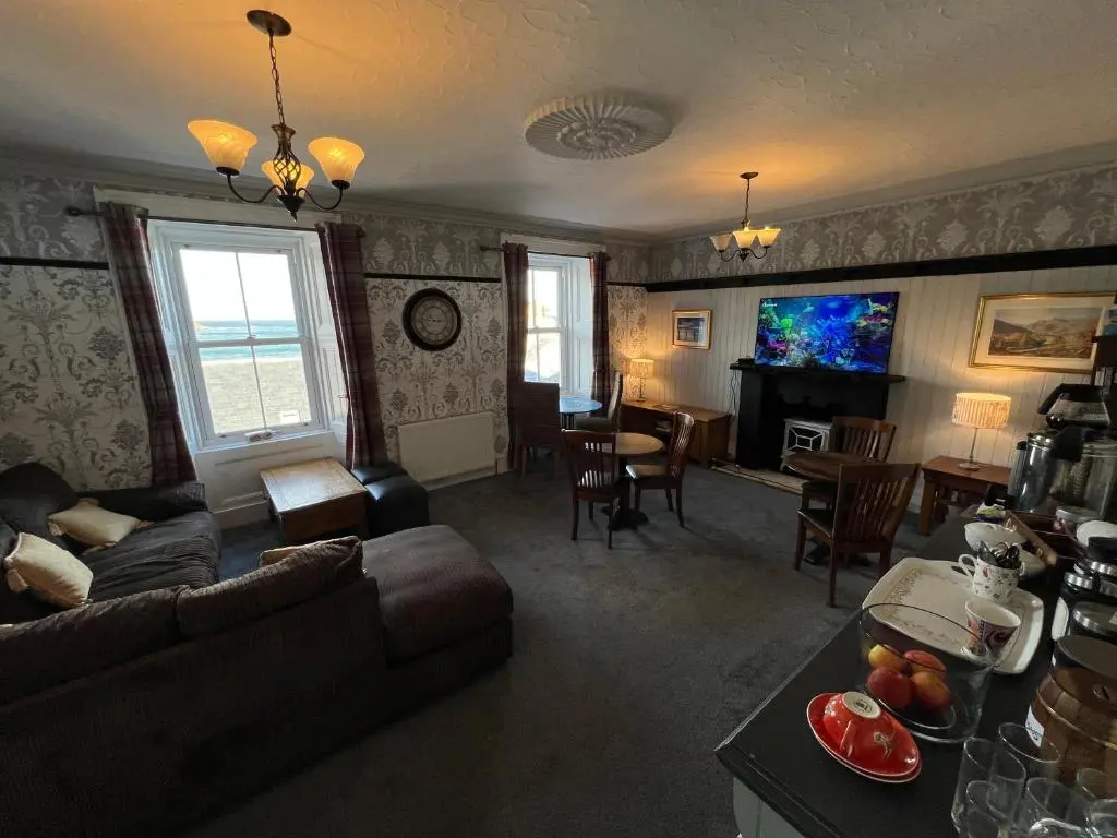 a living room with a couch and a table at The Garden Arms Pub and Rooms in Gardenstown