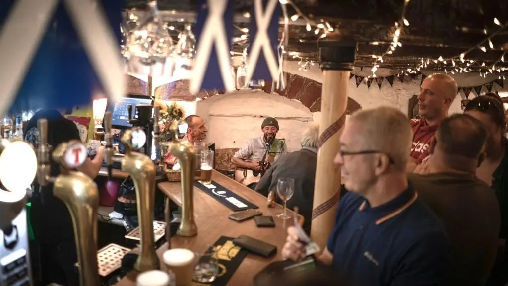 a group of people sitting at a bar at The Garden Arms Pub and Rooms in Gardenstown