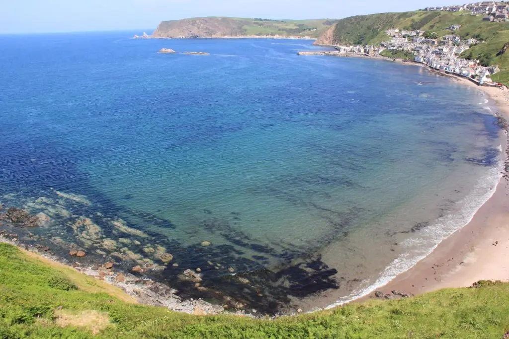an aerial view of a beach and the ocean at The Garden Arms Pub and Rooms in Gardenstown
