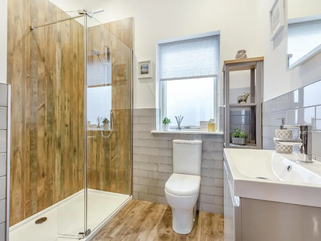 a bathroom with a shower and a toilet and a sink at Learag in Culbokie