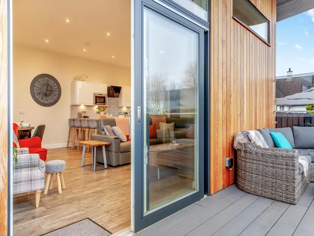 a sliding glass door leading to a living room at Learag in Culbokie