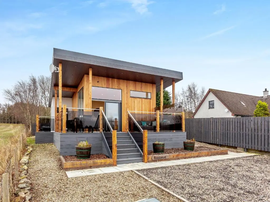 a modern house with a black roof at Learag in Culbokie