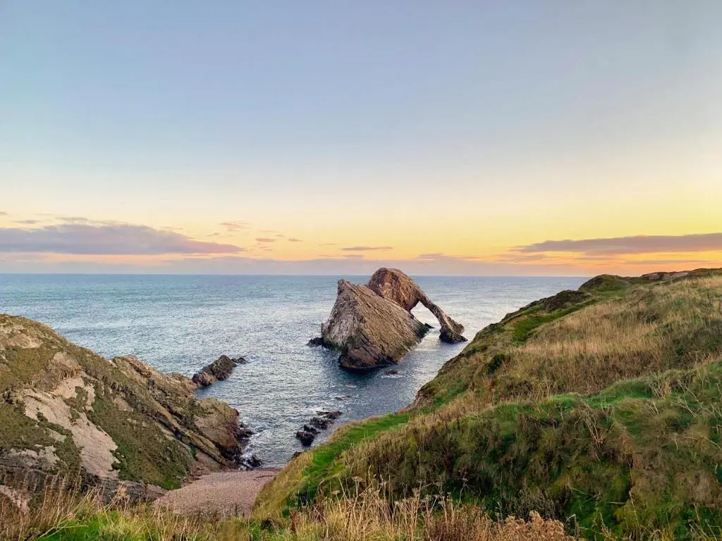 a view of the ocean with rocks in the water at Seahaven Cottage in Portknockie
