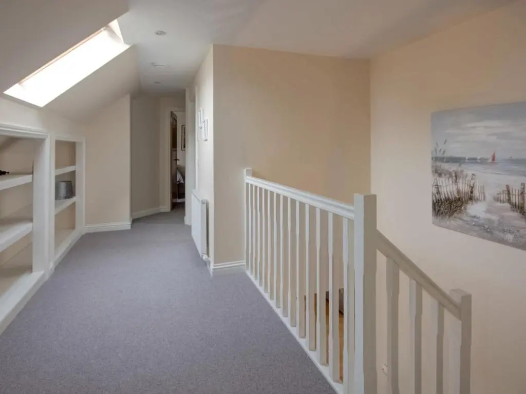 a hallway of a home with a staircase with a skylight at Darna House in Tain