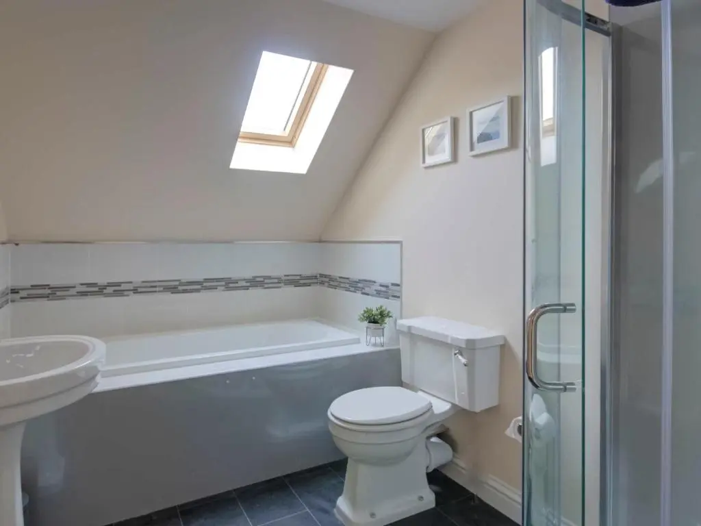 a bathroom with a toilet and a tub and a sink at Darna House in Tain