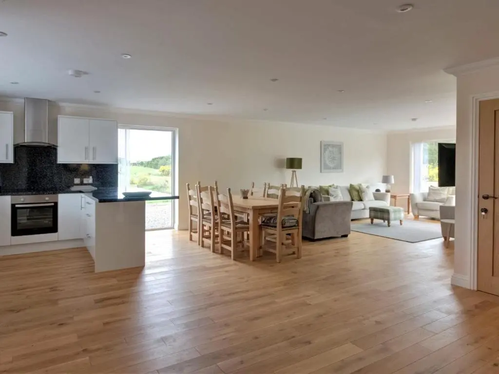a kitchen and living room with a table and chairs at Darna House in Tain
