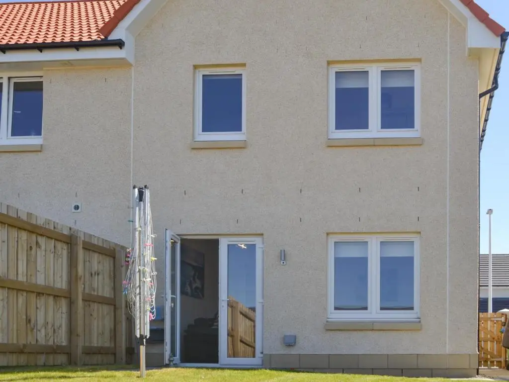 a house with its door open and a fence at Faillie in Inverness