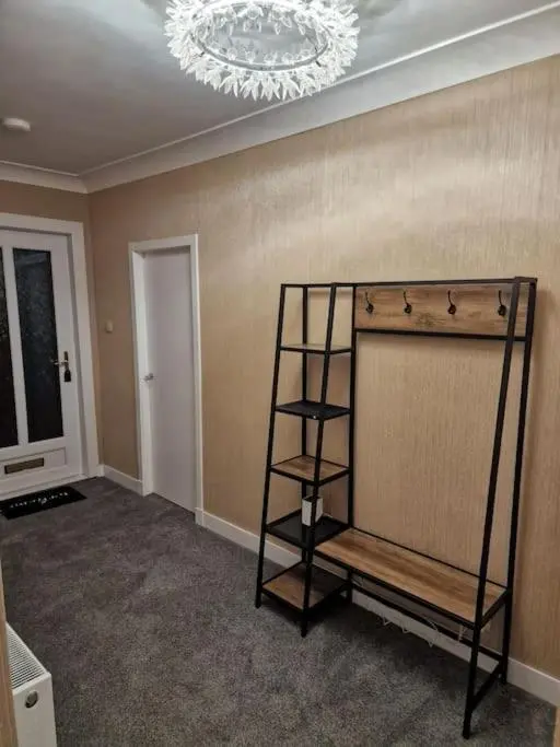 a room with a shelf and a chandelier at Catalina - Modern 2 bedroom bungalow in Elgin