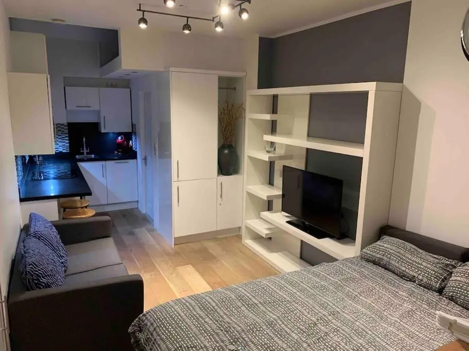 a living room with a bed and a kitchen at Luxury studio flat in a coastal town of Nairn in Nairn