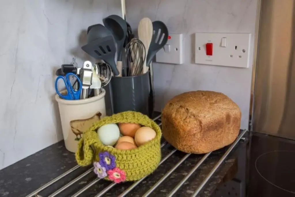a basket of eggs and a loaf of bread at The Garden Flat - Ardullie Lodge in Dingwall