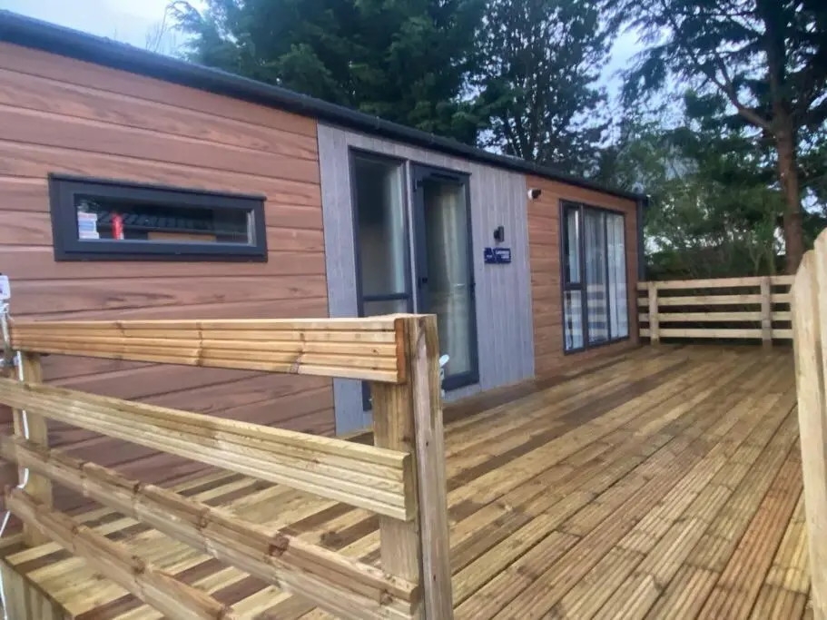 a wooden deck with a tiny house at Corrie Fee Lodge in Boat of Garten
