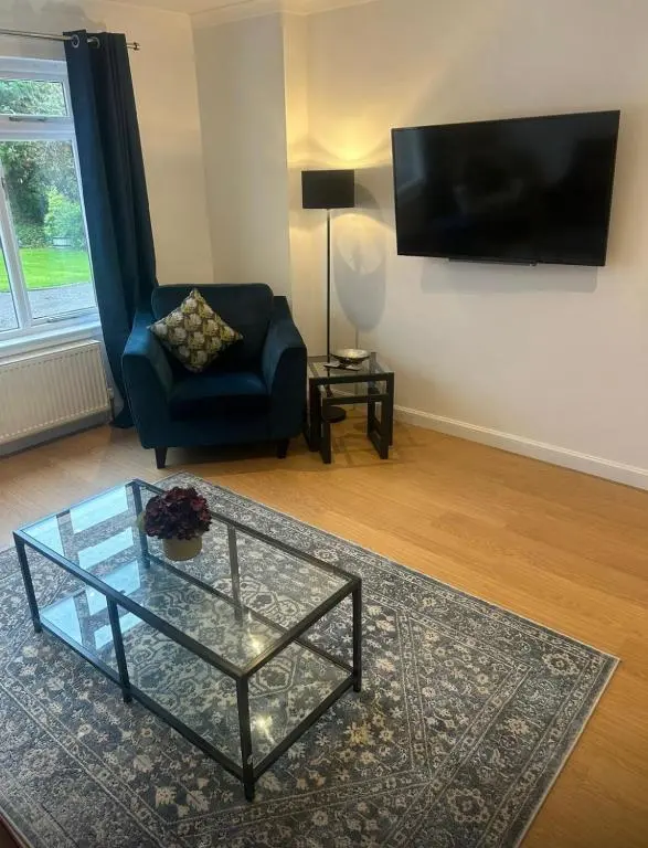 a living room with a couch and a glass coffee table at Balmanach Court in Beauly