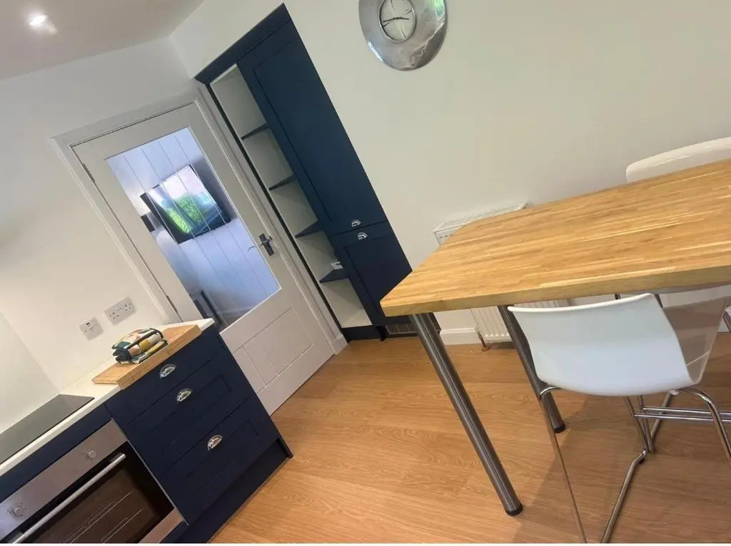a room with a desk and a table and a chair at Balmanach Court in Beauly