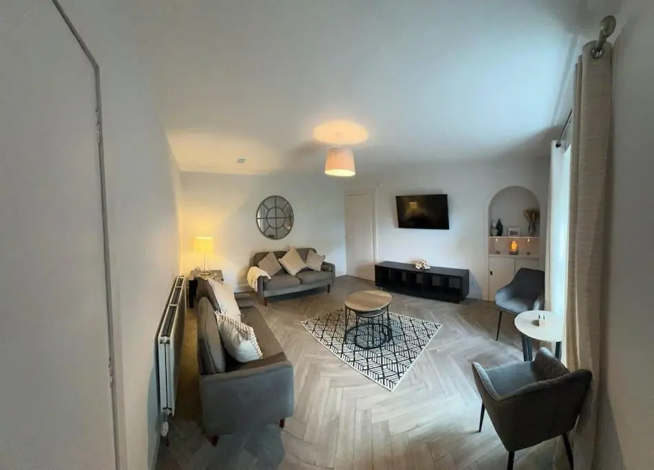 a living room with a couch and a table at 1 Links Place in Nairn