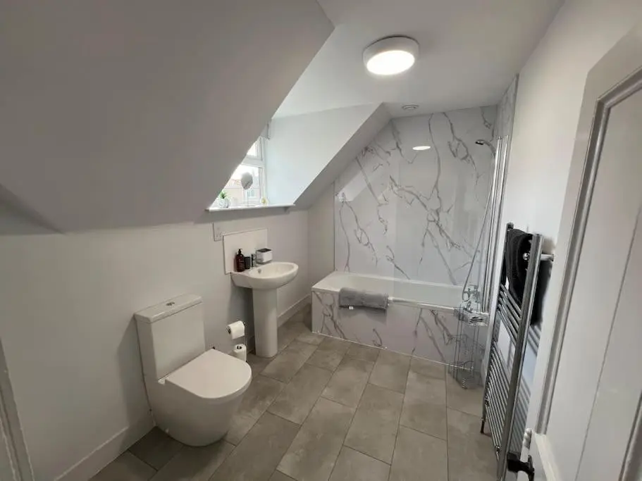 a bathroom with a toilet and a sink at 1 Links Place in Nairn