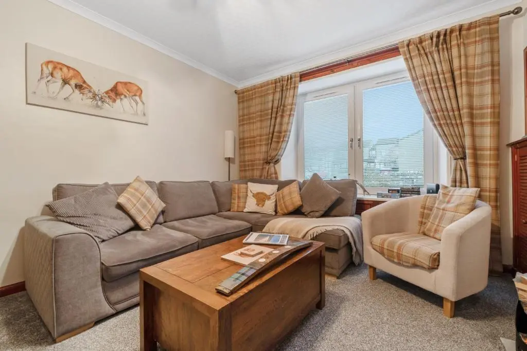 a living room with a couch and a table at Ramsay Lane in Lossiemouth