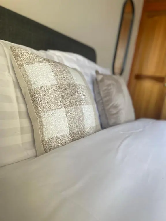 a close up of a bed with a pillow on it at Ramsay Lane in Lossiemouth