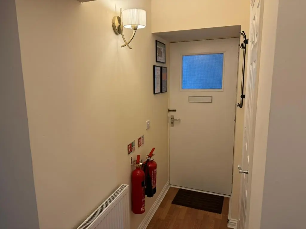 a hallway with two fire hydrants next to a door at 20a, By The Ness in Inverness
