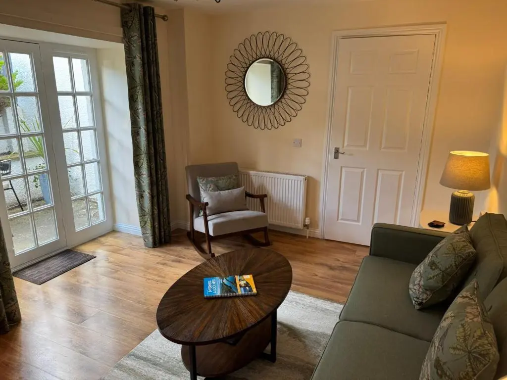 a living room with a couch and a table at 20a, By The Ness in Inverness