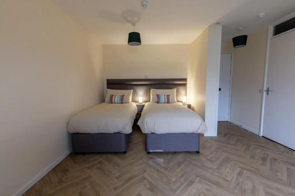 two beds in a room with two beds sidx sidx sidx sidx sidx sidx at Wick Bay Apartments in Wick