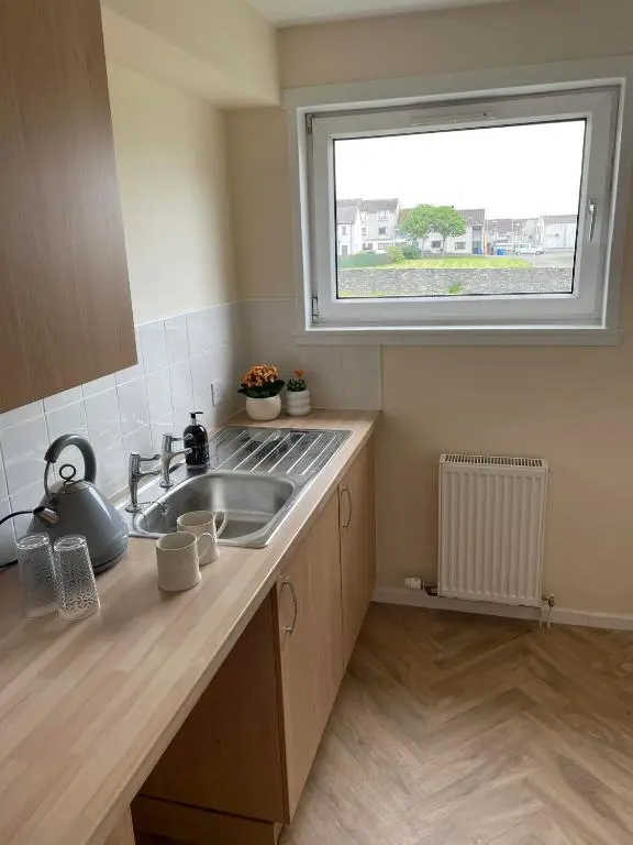 a kitchen with a sink and a window at Wick Bay Apartments in Wick
