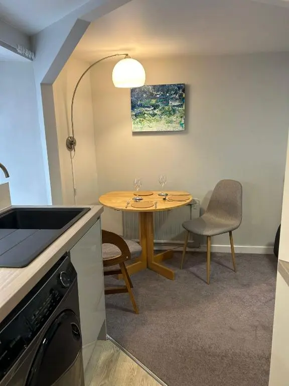 a small kitchen with a table and two chairs at 1 Bedroom Alexander Snug-Free Parking in Inverness