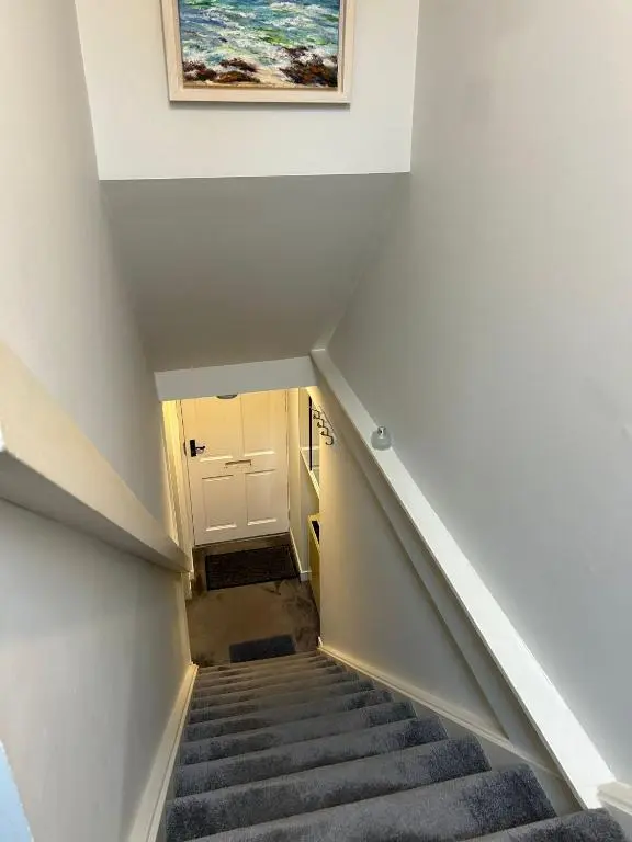 a staircase in a house with a painting on the wall at 1 Bedroom Alexander Snug-Free Parking in Inverness