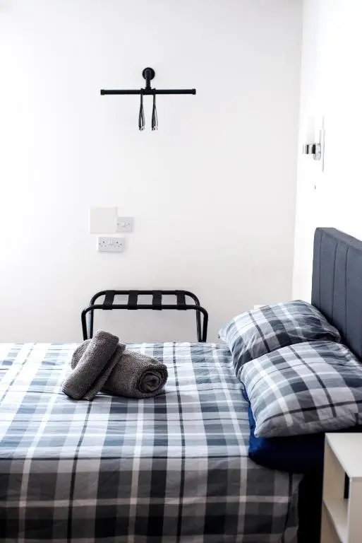 a bed with two pillows on it in a bedroom at Weston House in Keith
