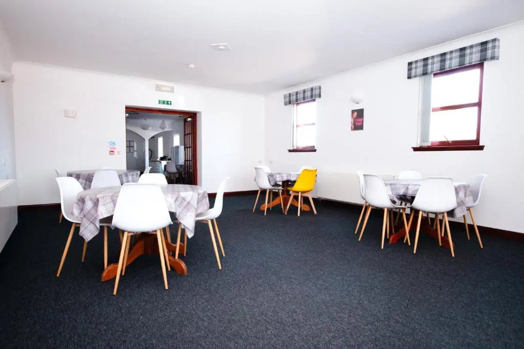 a conference room with a table and chairs at Weston House in Keith
